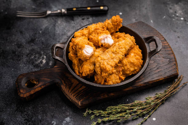 istock Fried chicken fillet tender strips. wooden background. top view 2185878397