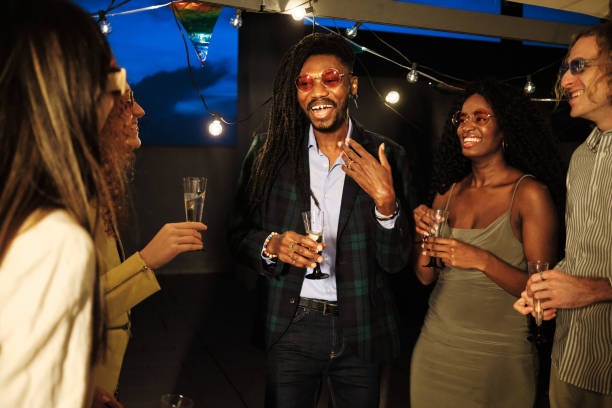 istock Multiethnic friends enjoying drinks at rooftop party 2185882904