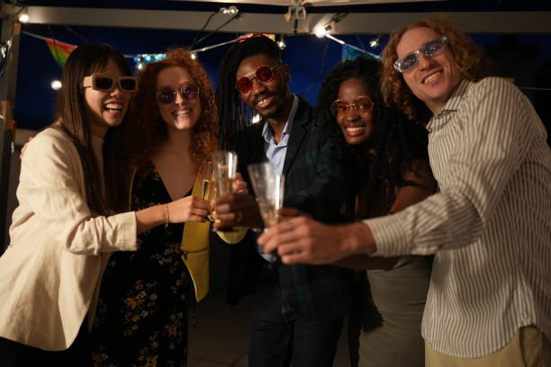 istock Multiethnic friends are toasting at a rooftop party 2185882950