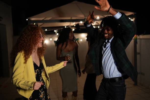istock Multiethnic friends dancing and enjoying rooftop party at night 2185883028