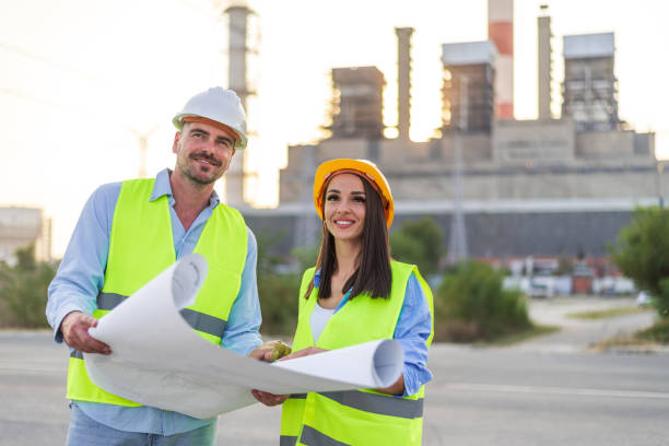 istock Two engineers holding blueprints discussing project at power plant 2185885270