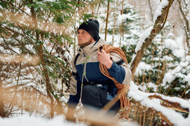 istock A determined mountaineer sails through a peaceful snow-covered forest, equipped with a rope and a backpack, embodying the spirit of adventure in the heart of winter. 2185887822