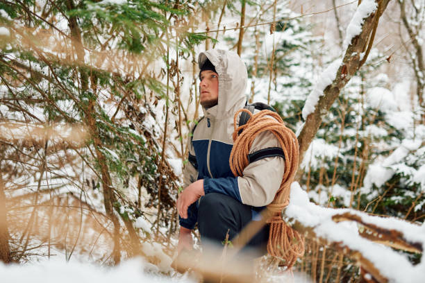 istock A determined mountaineer sails through a peaceful snow-covered forest, equipped with a rope and a backpack, embodying the spirit of adventure in the heart of winter. 2185888078