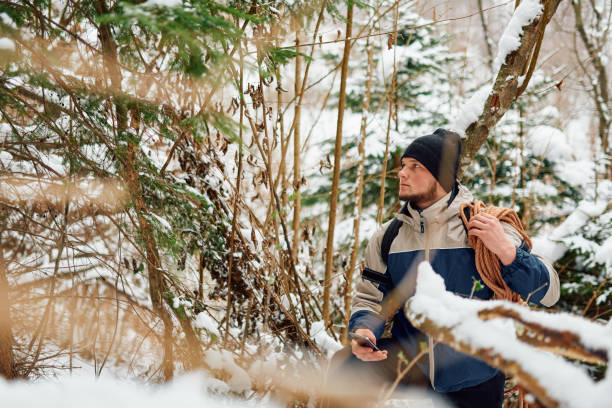 istock A determined mountaineer sails through a peaceful snow-covered forest, equipped with a rope and a backpack, embodying the spirit of adventure in the heart of winter. 2185888367