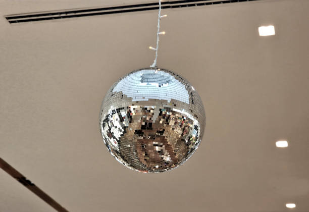 istock a disco ball composed of small square-shaped mirrors. reflecting light rays on the surrounding walls in the hall. Christmas decoration in a modern silver design 2185889265