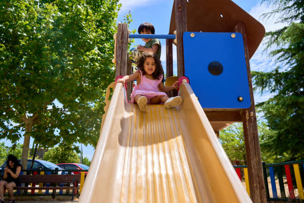 istock child playing in an outdoor playground 2185890612