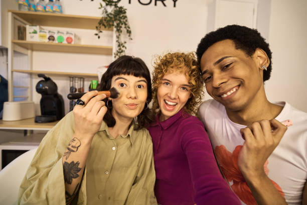 istock Three cheerful multi-ethnic friends are applying makeup and taking a selfie 2185890989