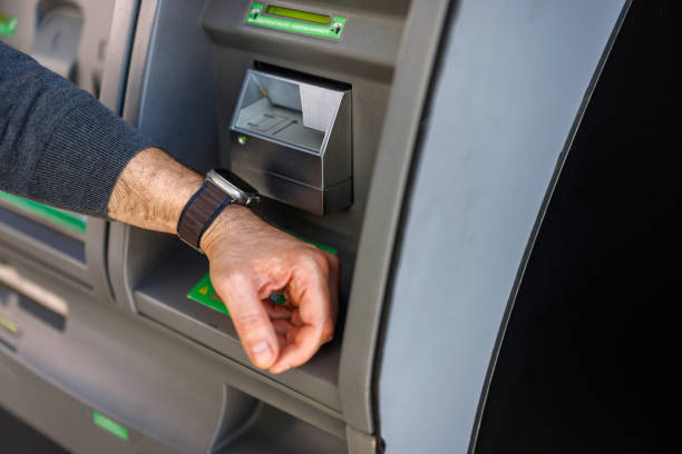 istock Man using smartwatch to operate ATM at travel exchange hub. 2185891236