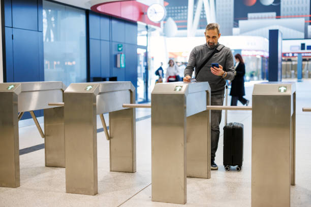 istock Traveler verifying information at gate with luggage in transit. 2185891337