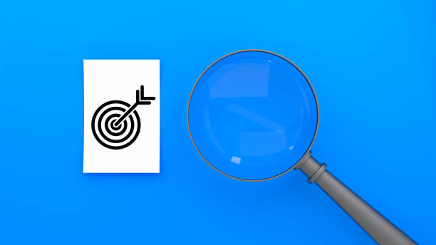 istock White paper with black target icon, magnifying glass, vibrant blue background, conceptual business imagery, high contrast, goal-oriented, search and discovery theme. 3D render. 2185894562