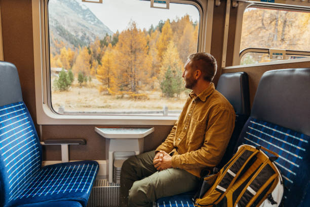 istock Man Admiring Autumn Landscape from Train Window 2185898317