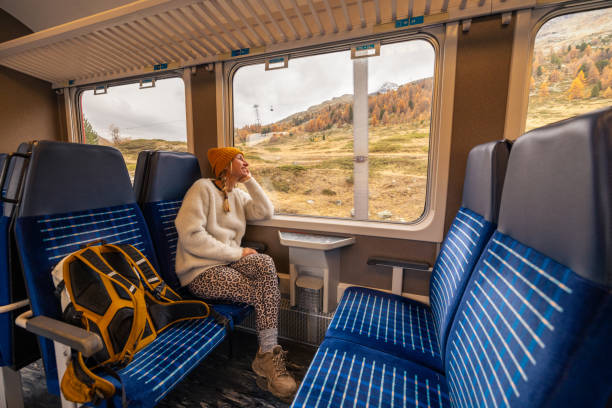 istock Woman Enjoying Scenic Train Ride in Autumn 2185898404