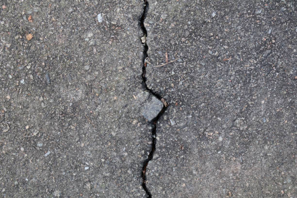 istock Close-Up of a Crack in Concrete Pavement 2185899200
