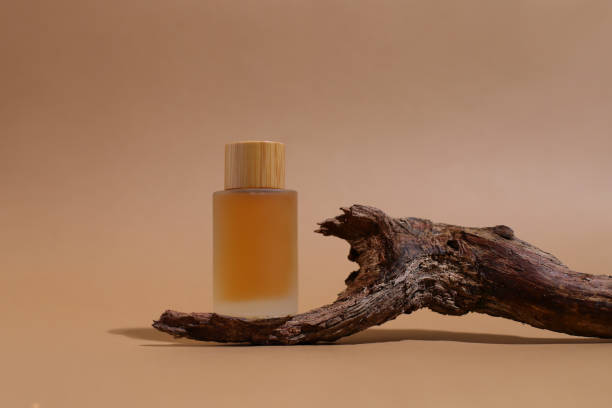 istock Glass cosmetic bottle with wooden trunk, container mockup 2185903481