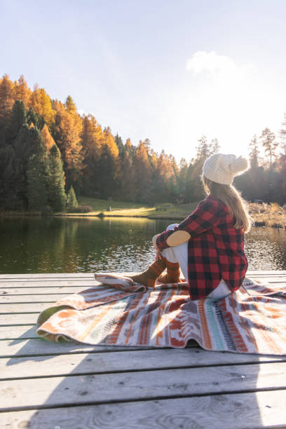 istock Relaxing on a Pier by a Tranquil Lake in Autumn 2185903632