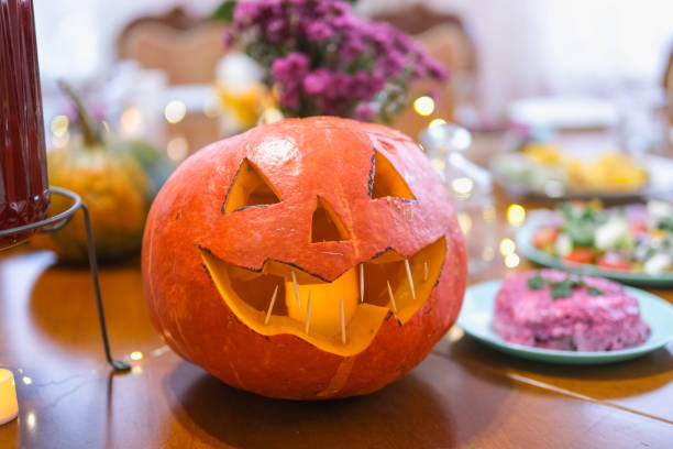 istock Halloween handmade pumpkin head jack lantern is on the table. 2185904509