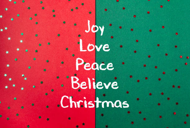 Green and red background with stars and the words joy, love, peace, believe, Christmas written in white