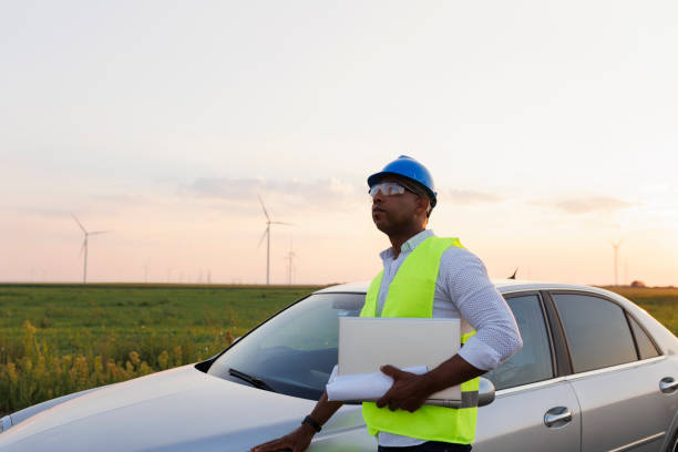 istock Young Engineer wearing uniform ,helmet hold document inspection work in wind turbine farms rotation to generate electricity energy 2185905958