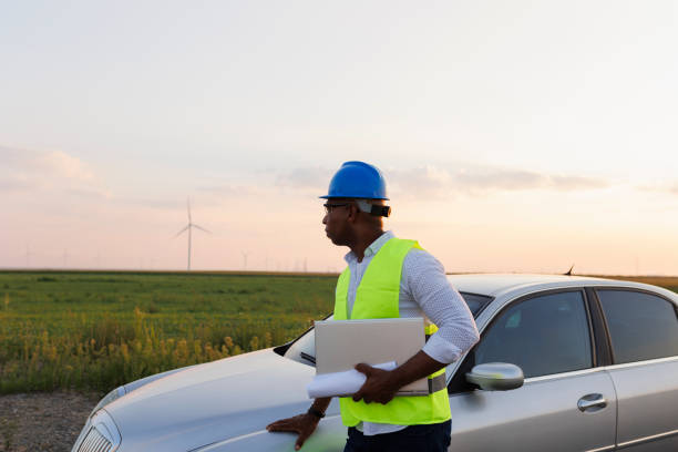 istock Young Engineer wearing uniform ,helmet hold document inspection work in wind turbine farms rotation to generate electricity energy 2185906152