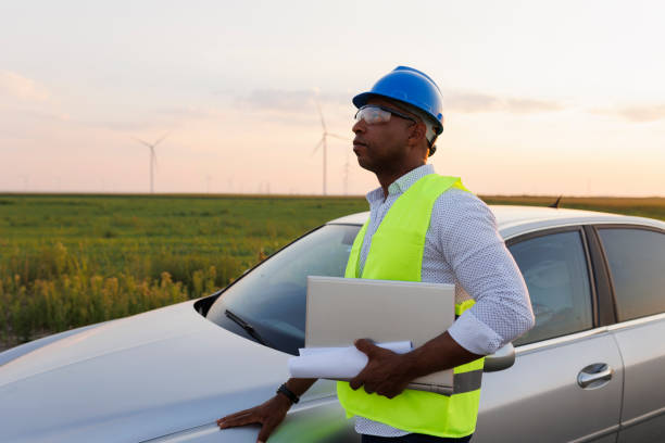 istock Young Engineer wearing uniform ,helmet hold document inspection work in wind turbine farms rotation to generate electricity energy 2185906227
