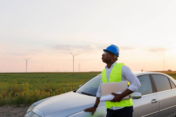 istock Young Engineer wearing uniform ,helmet hold document inspection work in wind turbine farms rotation to generate electricity energy 2185906247
