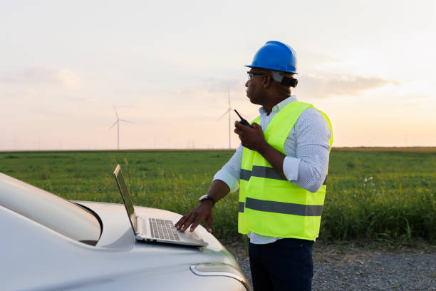 istock Young Engineer wearing uniform ,helmet hold document inspection work in wind turbine farms rotation to generate electricity energy 2185906369