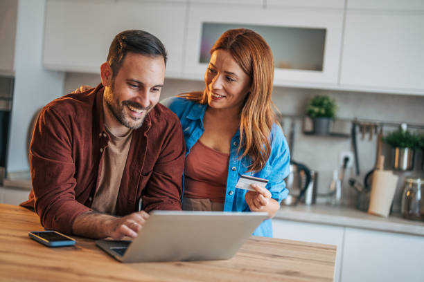 istock A cheerful husband and wife are standing in the kitchen. 2185906372