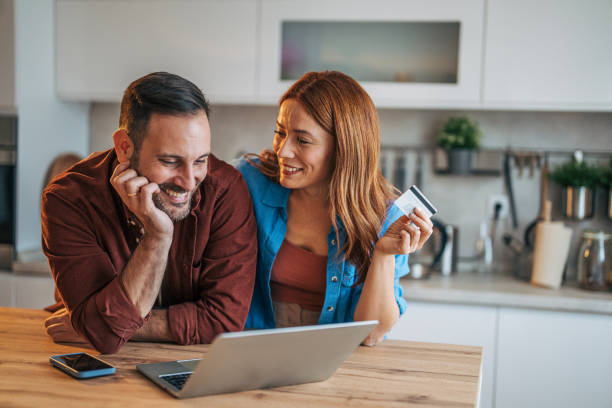 istock A cheerful husband and wife are standing in the kitchen. 2185906455