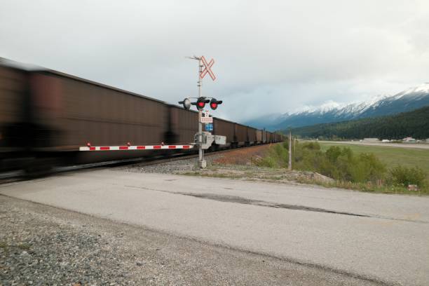istock Freight train passing with snowy mountains in the background. 2185906799