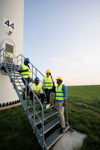 istock Engineers wearing uniform ,helmet hold document inspection work in wind turbine farms rotation to generate electricity energy 2185906948