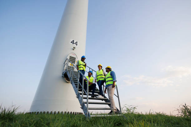 istock Engineers wearing uniform ,helmet hold document inspection work in wind turbine farms rotation to generate electricity energy 2185907015