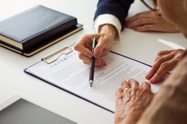 istock Senior woman discussing contract with lawyer 2185907026