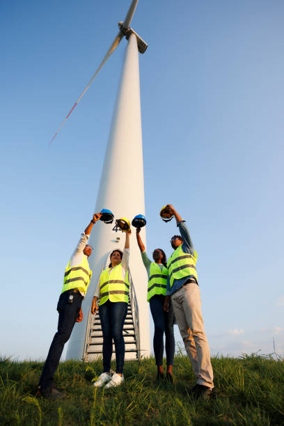 istock Engineers wearing uniform ,helmet hold document inspection work in wind turbine farms rotation to generate electricity energy 2185907033