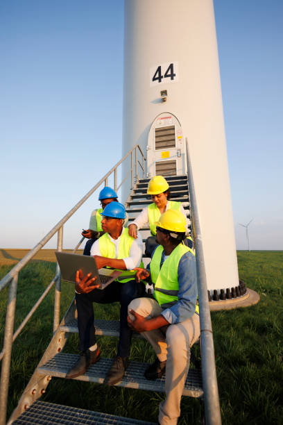 istock Engineers wearing uniform ,helmet hold document inspection work in wind turbine farms rotation to generate electricity energy 2185907086