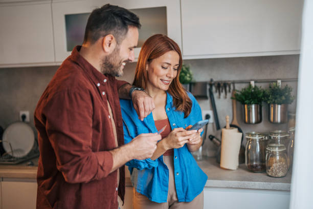 istock A cheerful husband and wife are standing in the kitchen. 2185907171