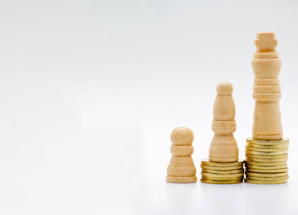 istock Pawns on golden coins representing status with customizable space for text 2185907884