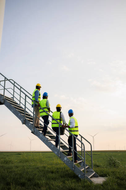 istock Engineers wearing uniform ,helmet hold document inspection work in wind turbine farms rotation to generate electricity energy. 2185907962