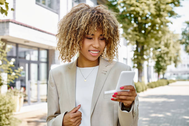 istock Young businesswoman engaged in work while using her smartphone in a modern outdoor setting 2185908657