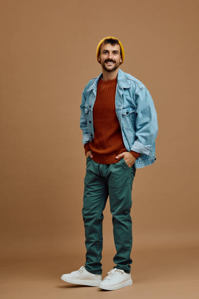 istock Happy man with hands in pockets looking at camera. 2185909851