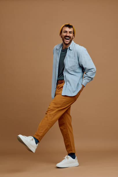 istock Studio shot of happy man having fun while walking and looking at camera. 2185909941
