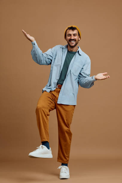 istock Studio shot of happy man balancing with hands while looking at camera 2185909966