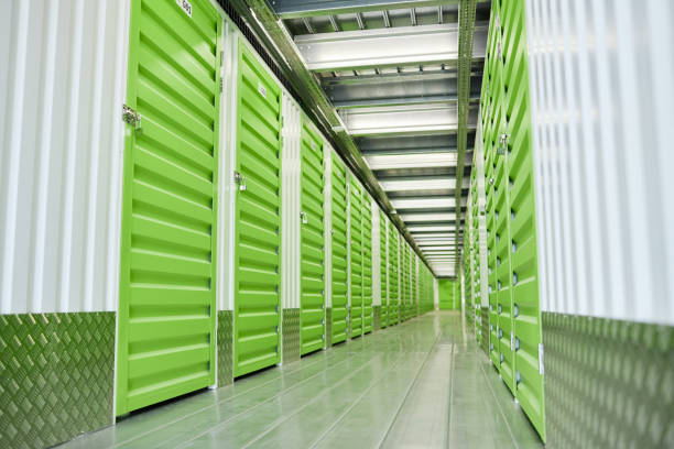 istock Passway with Green Doors Opening into Self Storage Units at Warehouse 2185912463