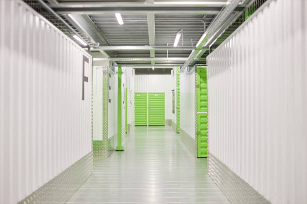 istock White Aisle with Green Doors Leading to Self Storage Units at Warehouse 2185912481