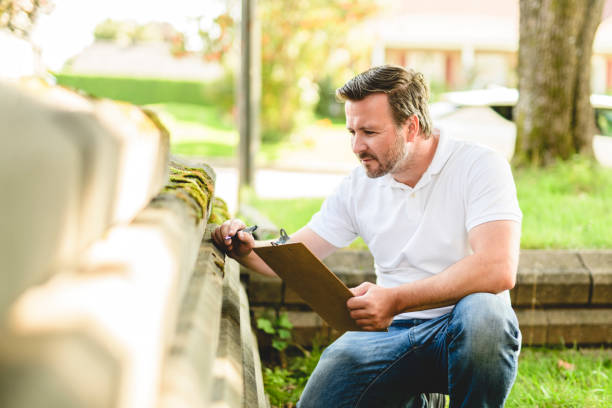istock inspector or engineer is checking the building structure and house. After the renovate is complete 2185914874