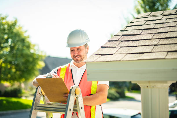 istock man with hard hat standing on steps inspecting house roof 2185914931