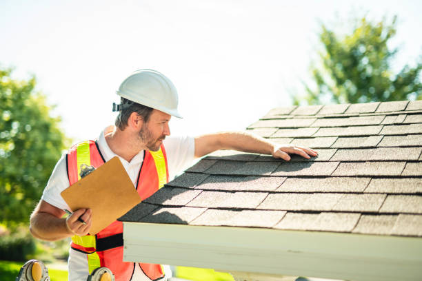 istock man with hard hat standing on steps inspecting house roof 2185914934