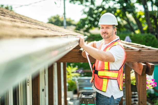 istock man with hard hat standing on steps inspecting house roof 2185914952