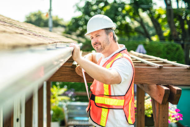 istock man with hard hat standing on steps inspecting house roof 2185914953