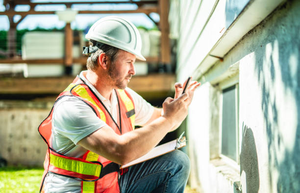 istock inspector or engineer is checking the building structure and house. After the renovate is complete 2185915002