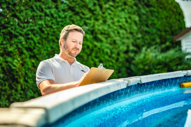 An engineer inspecting the build of swimming pool.